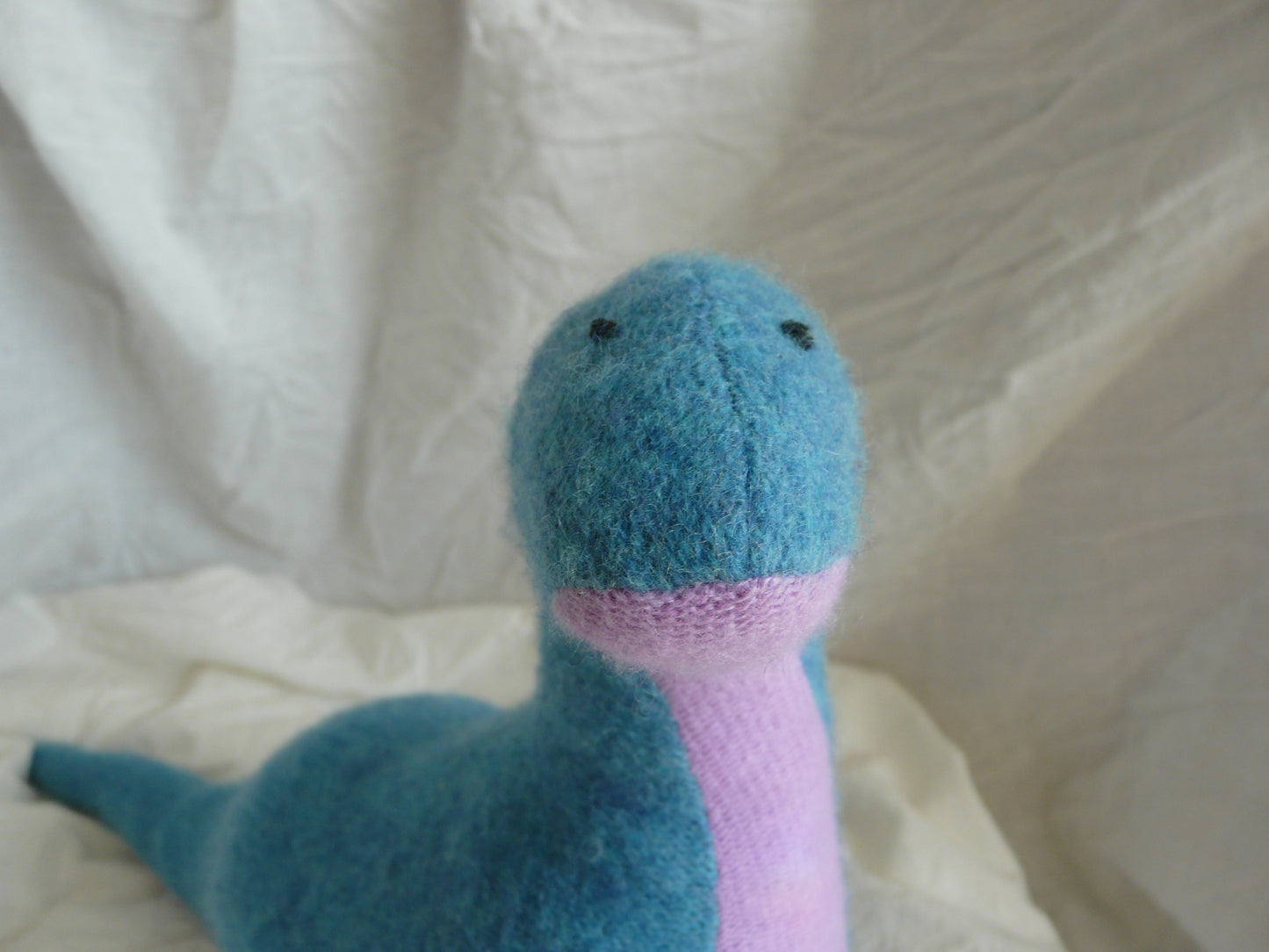 Tall blue and pink stuffed dinosaur